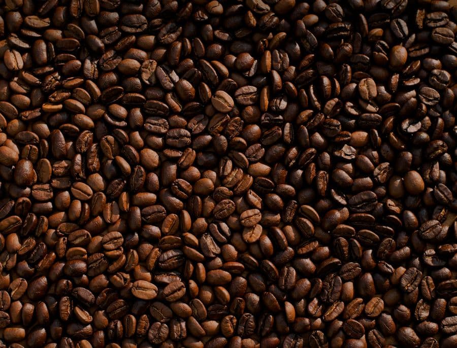 Coffee beans and cup on timber