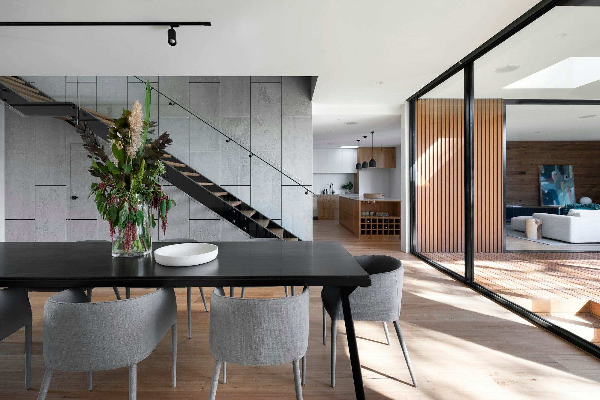 Black stone kitchen and dining space in an architect-designed home